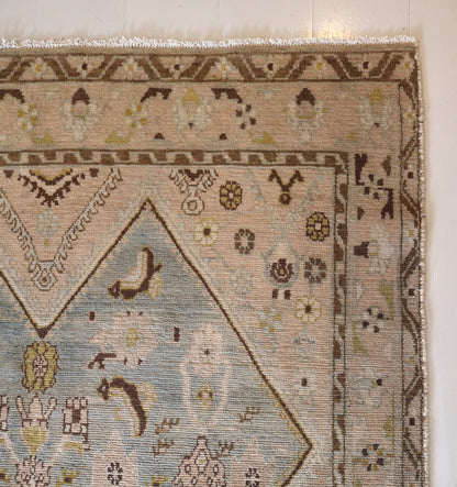 Malayer with muted colours and light blue centre